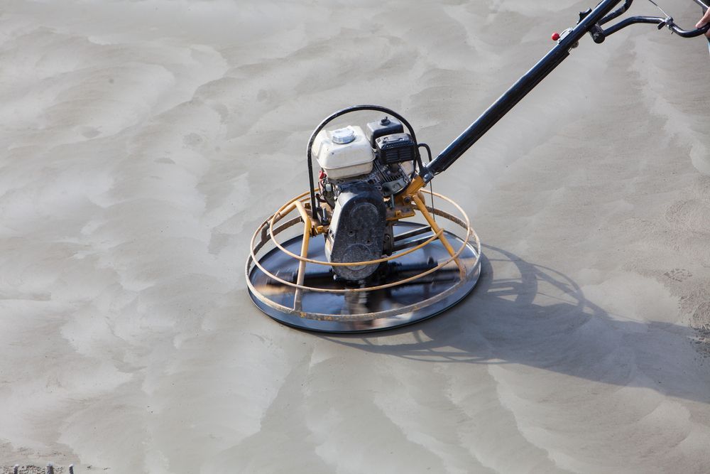 Power Trowel Smoothing Wet Concrete on a Construction Site — On The Grind In Bongaree, QLD