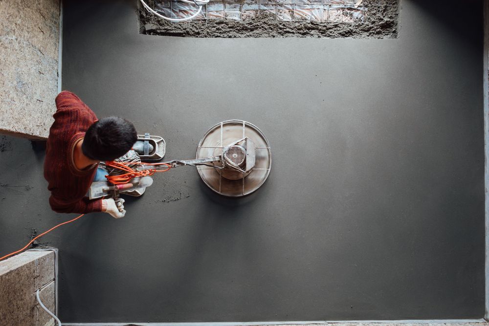 Person Uses a Concrete Grinder on a Grey Floor — On The Grind In Bongaree, QLD