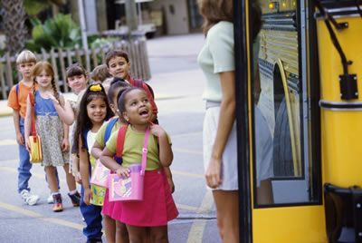 Kids are lining up to enter the school bus. Back to school.