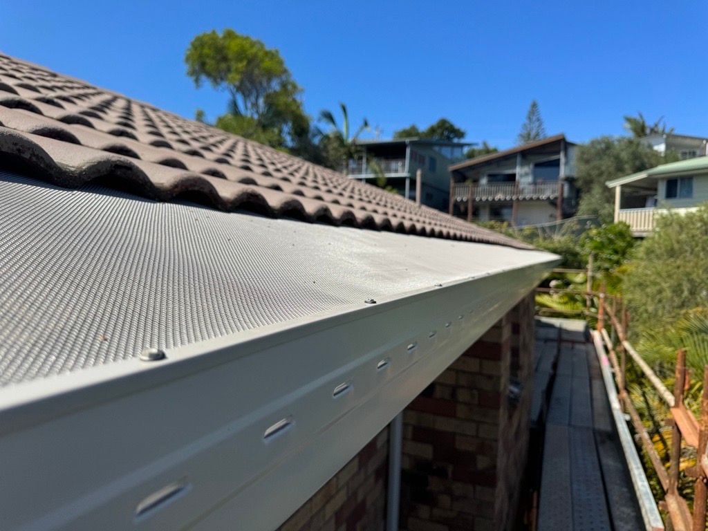 Metal Guard Over Gutter On A Roof — Gutter Guards In Lismore NSW