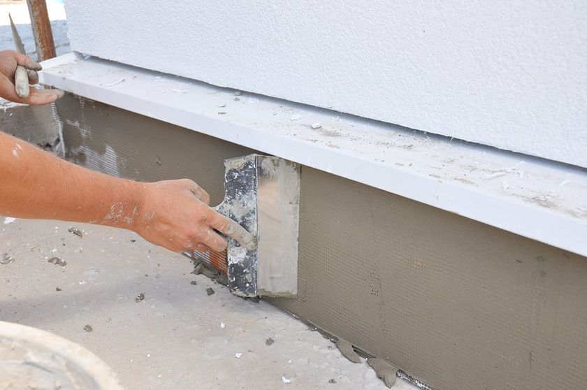 worker scraping the cement