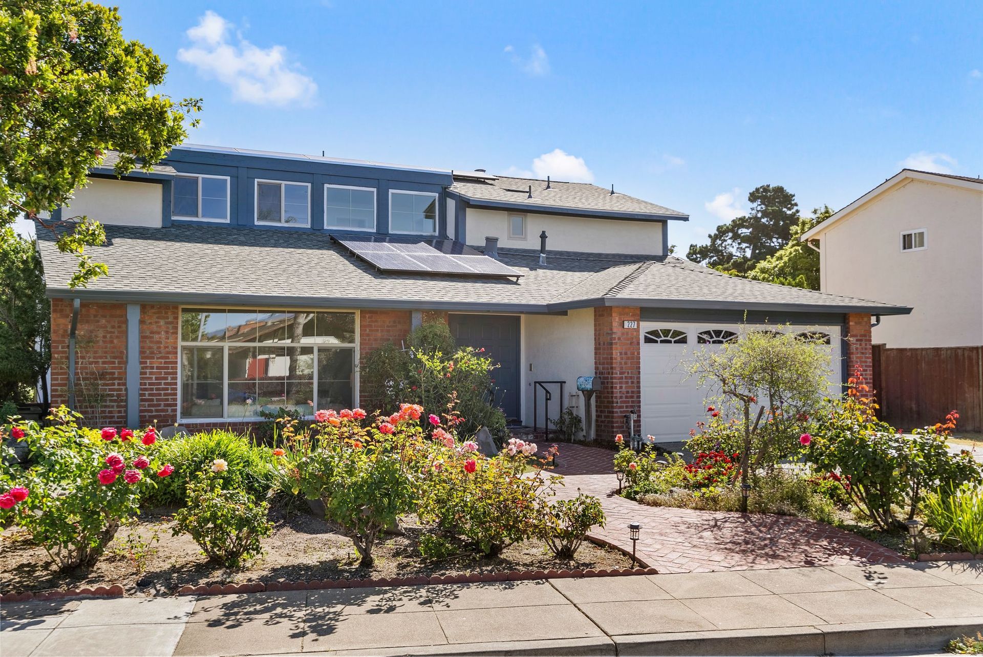 A house with a lot of flowers in front of it