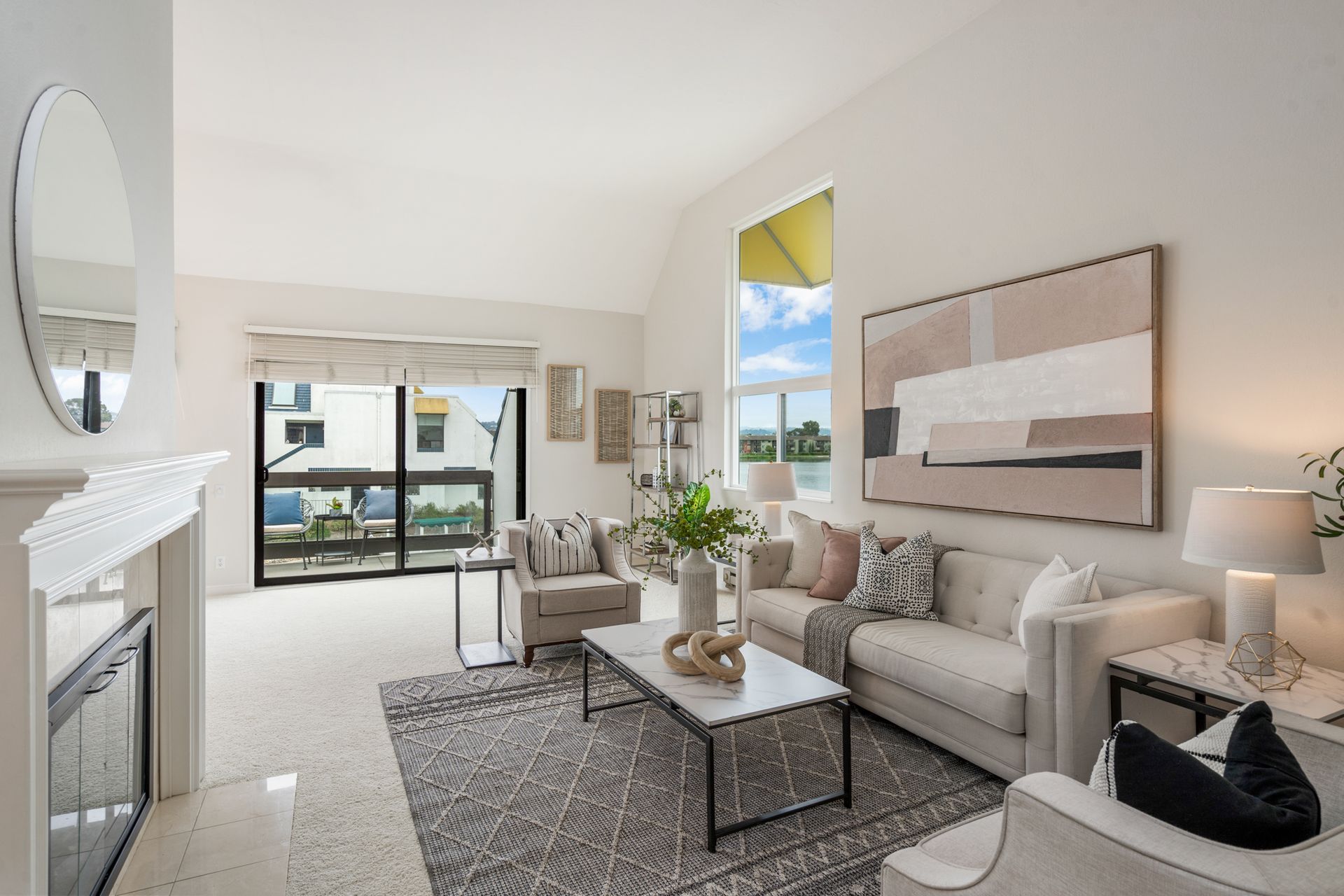 A living room with a couch , chair , coffee table and fireplace.