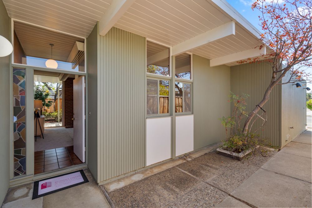 Welcoming mid-century exterior framed by mature landscaping, presented by Rumana Jabeen & Associates to inspire buyers and show sellers how curb appeal is marketed.