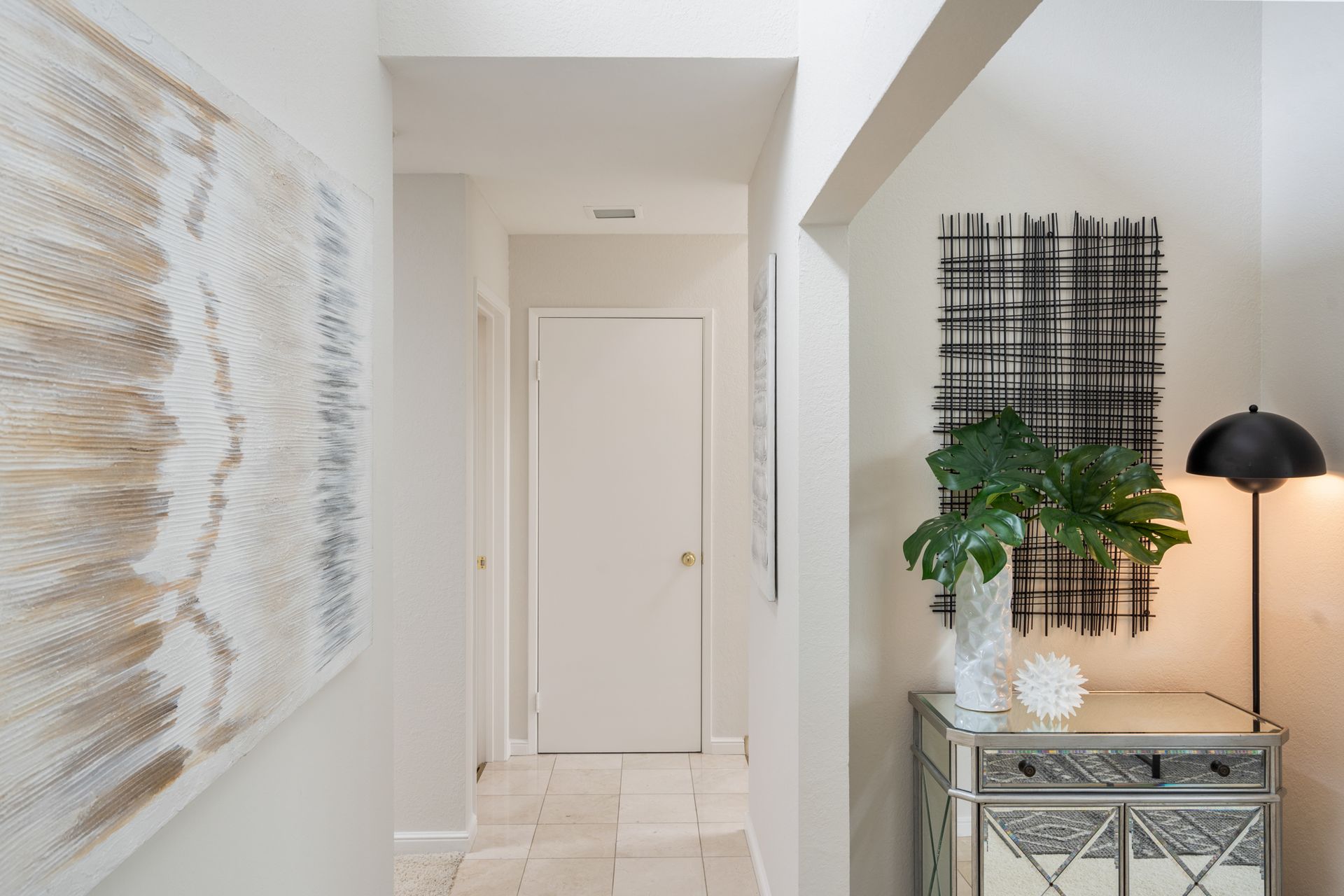 There is a painting on the wall in the hallway.