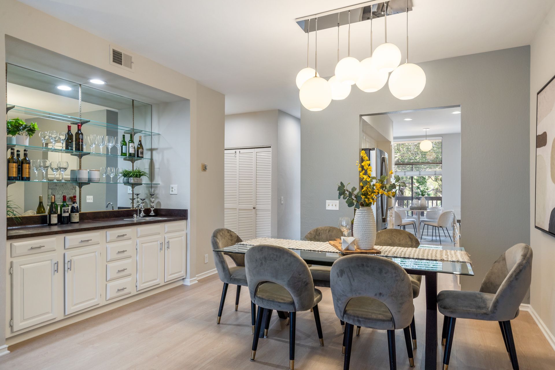 A dining room with a table and chairs and a bar.