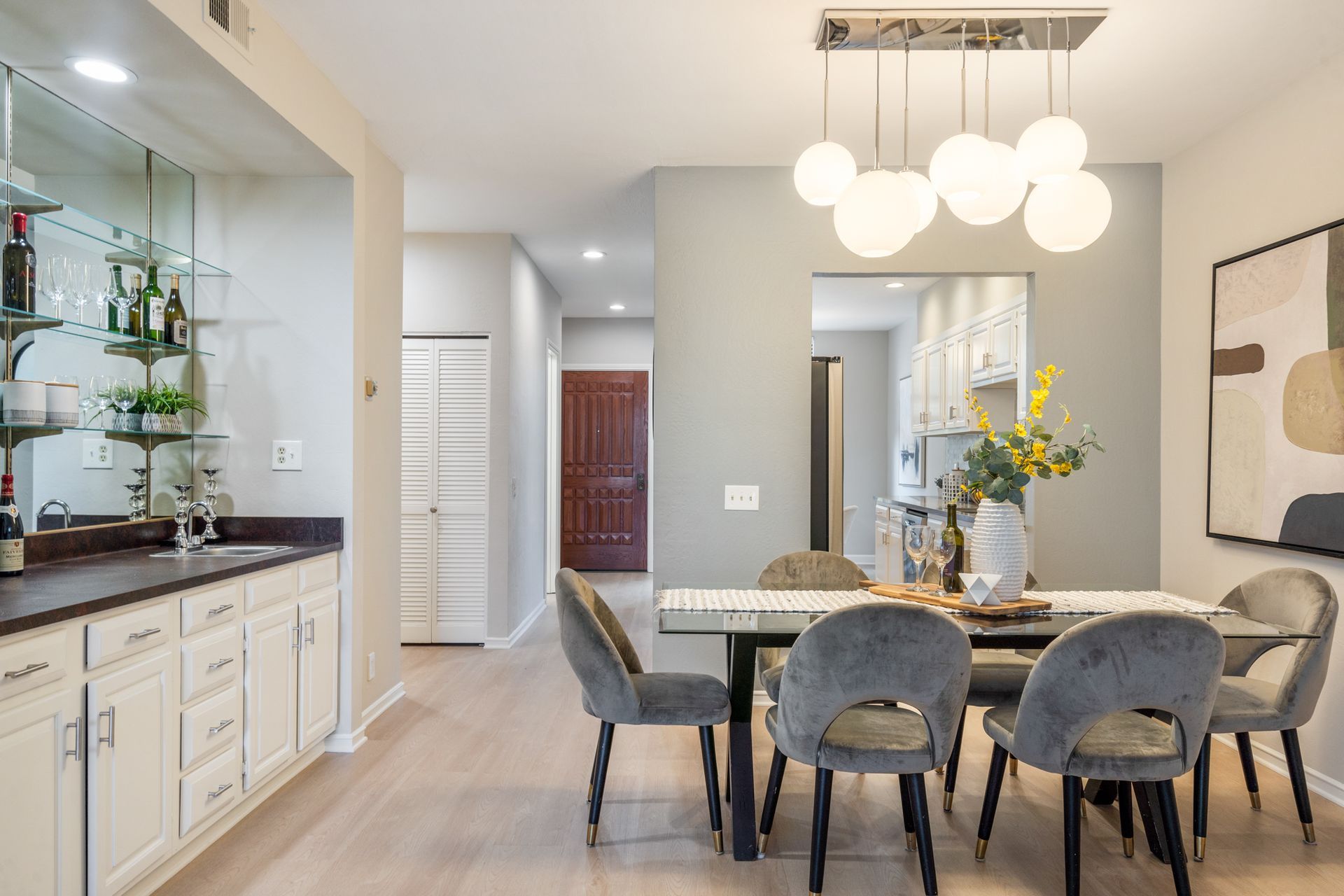 A dining room with a table and chairs and a chandelier.