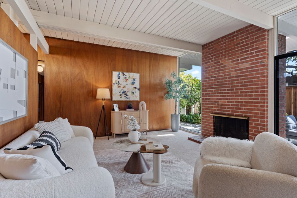 Open living and dining room with natural light, fireplace, and glass doors — Rumana Jabeen & Associates highlight flow and atmosphere buyers value and sellers can showcase.