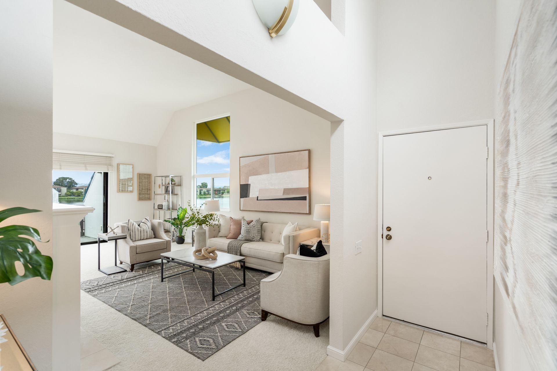 A living room with a couch , chairs , and a coffee table