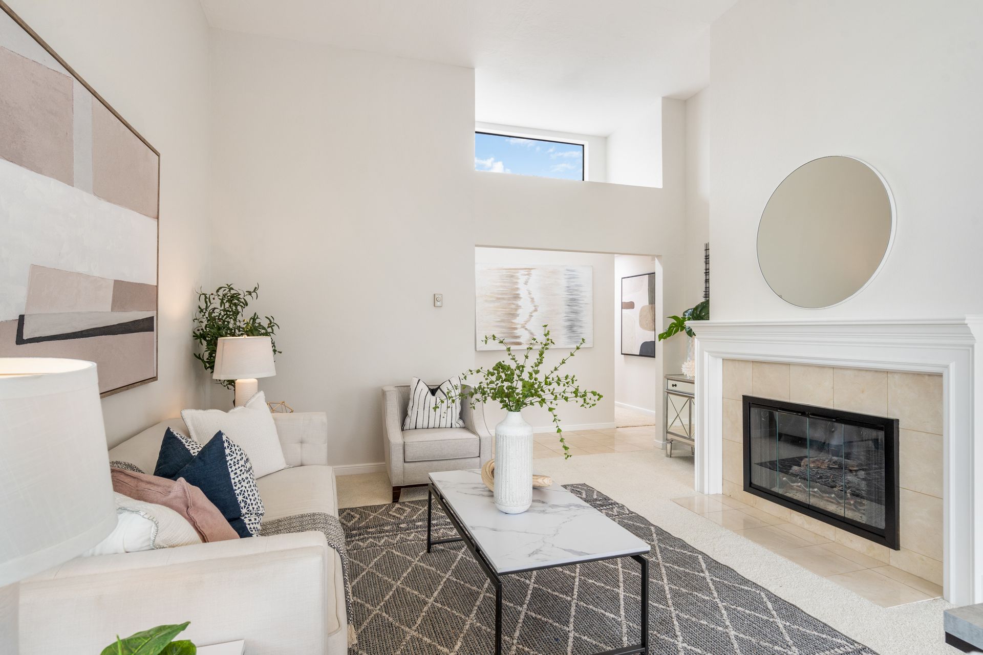 A living room filled with furniture and a fireplace.