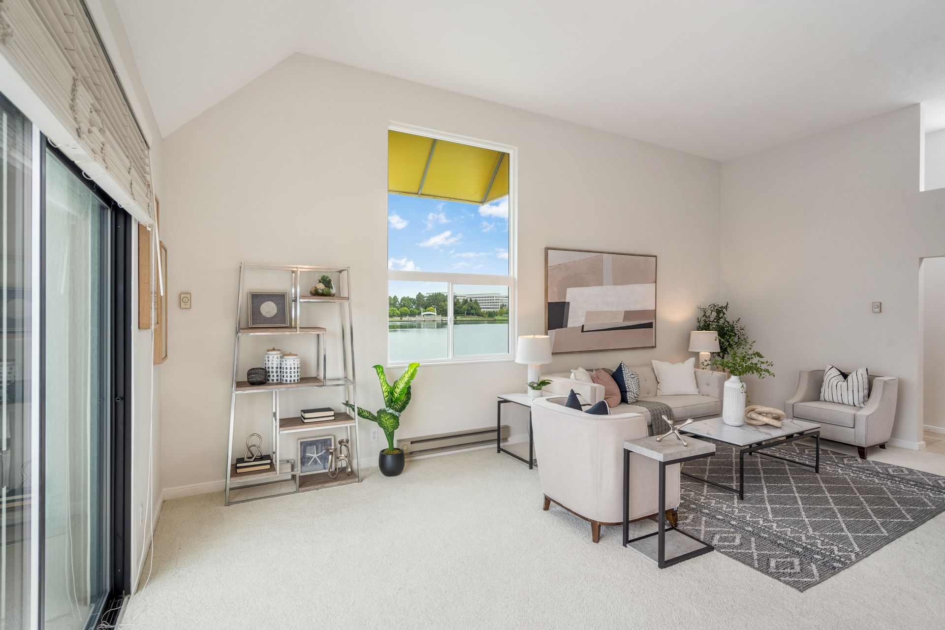 A living room filled with furniture and a large window.