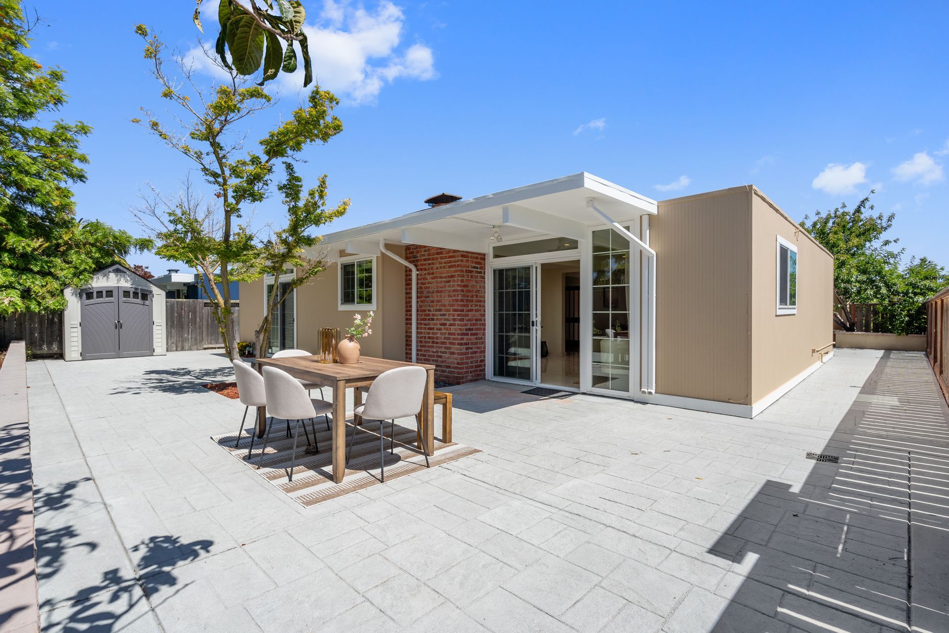 A house with a table and chairs in front of it