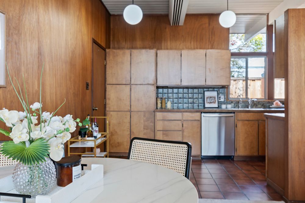 Open living and dining room with natural light, fireplace, and glass doors — Rumana Jabeen & Associates highlight flow and atmosphere buyers value and sellers can showcase.