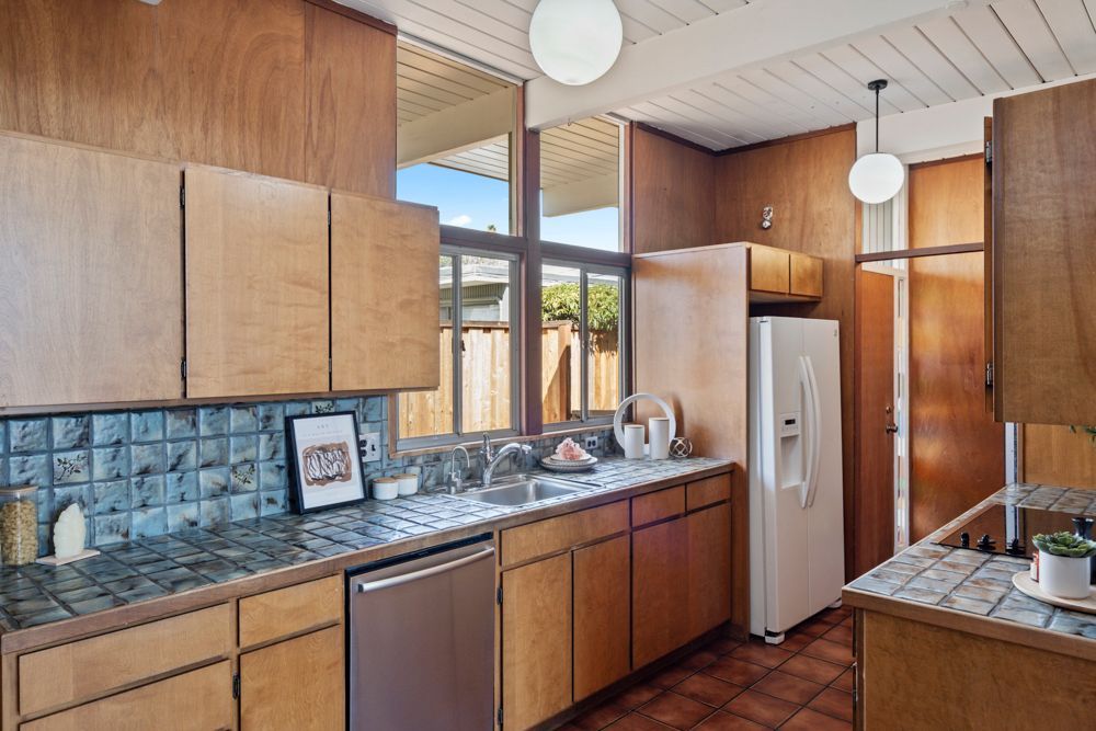 Galley kitchen with wood cabinetry and vintage charm, represented by Rumana Jabeen & Associates to appeal to buyers seeking character and assure sellers of thoughtful presentation.