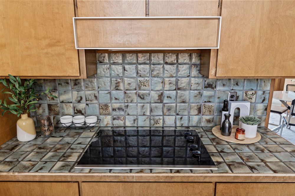 Galley kitchen with wood cabinetry and vintage charm, represented by Rumana Jabeen & Associates to appeal to buyers seeking character and assure sellers of thoughtful presentation.