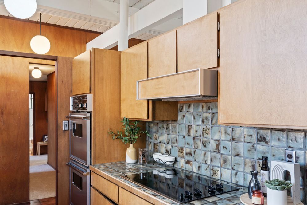 Galley kitchen with wood cabinetry and vintage charm, represented by Rumana Jabeen & Associates to appeal to buyers seeking character and assure sellers of thoughtful presentation.