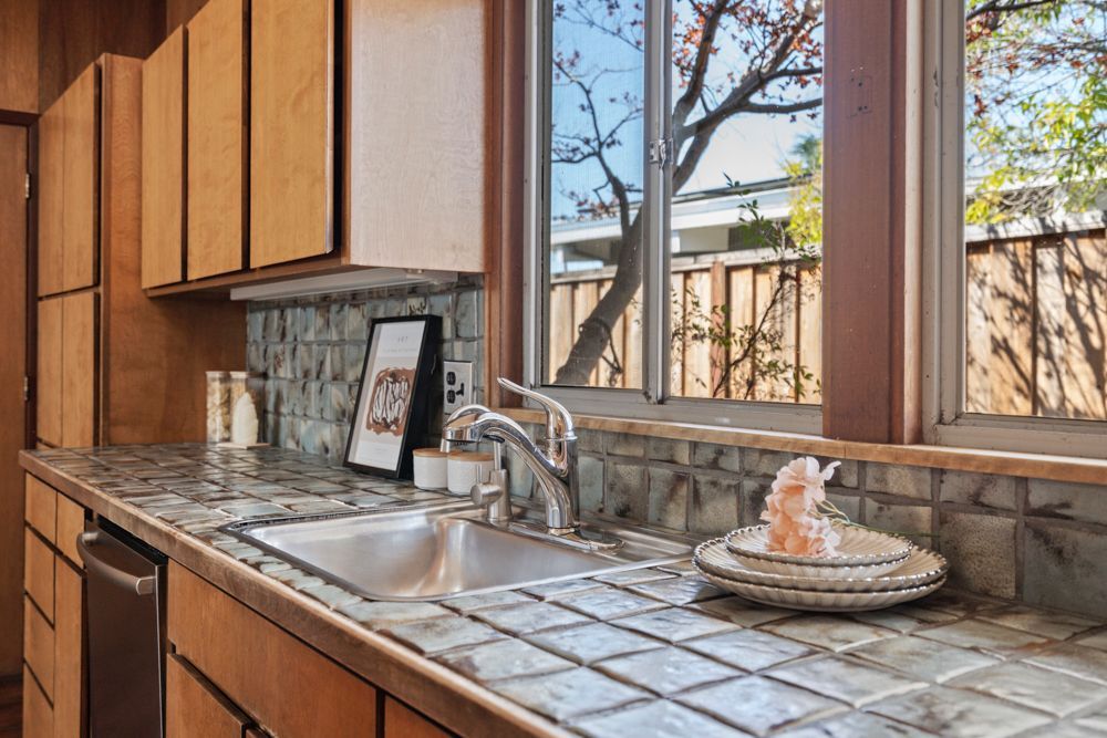 Galley kitchen with wood cabinetry and vintage charm, represented by Rumana Jabeen & Associates to appeal to buyers seeking character and assure sellers of thoughtful presentation.