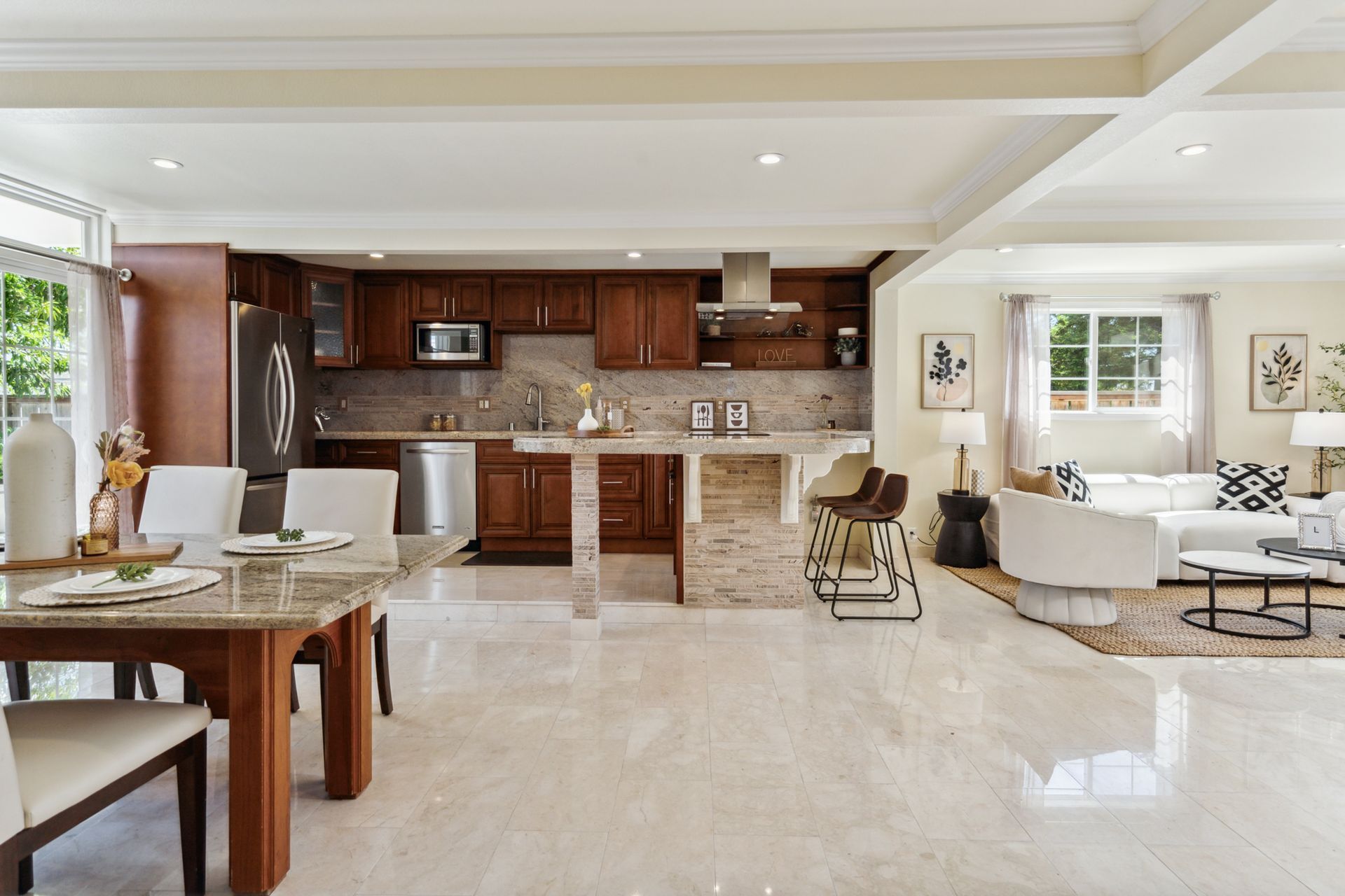 A living room with a table and chairs and a kitchen