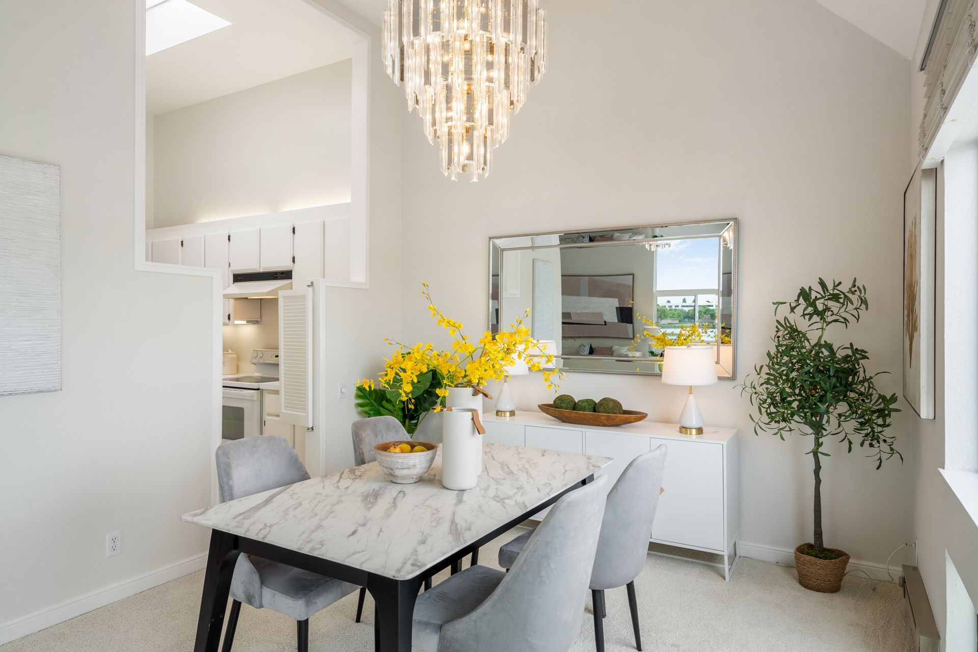 A dining room with a table and chairs and a chandelier.