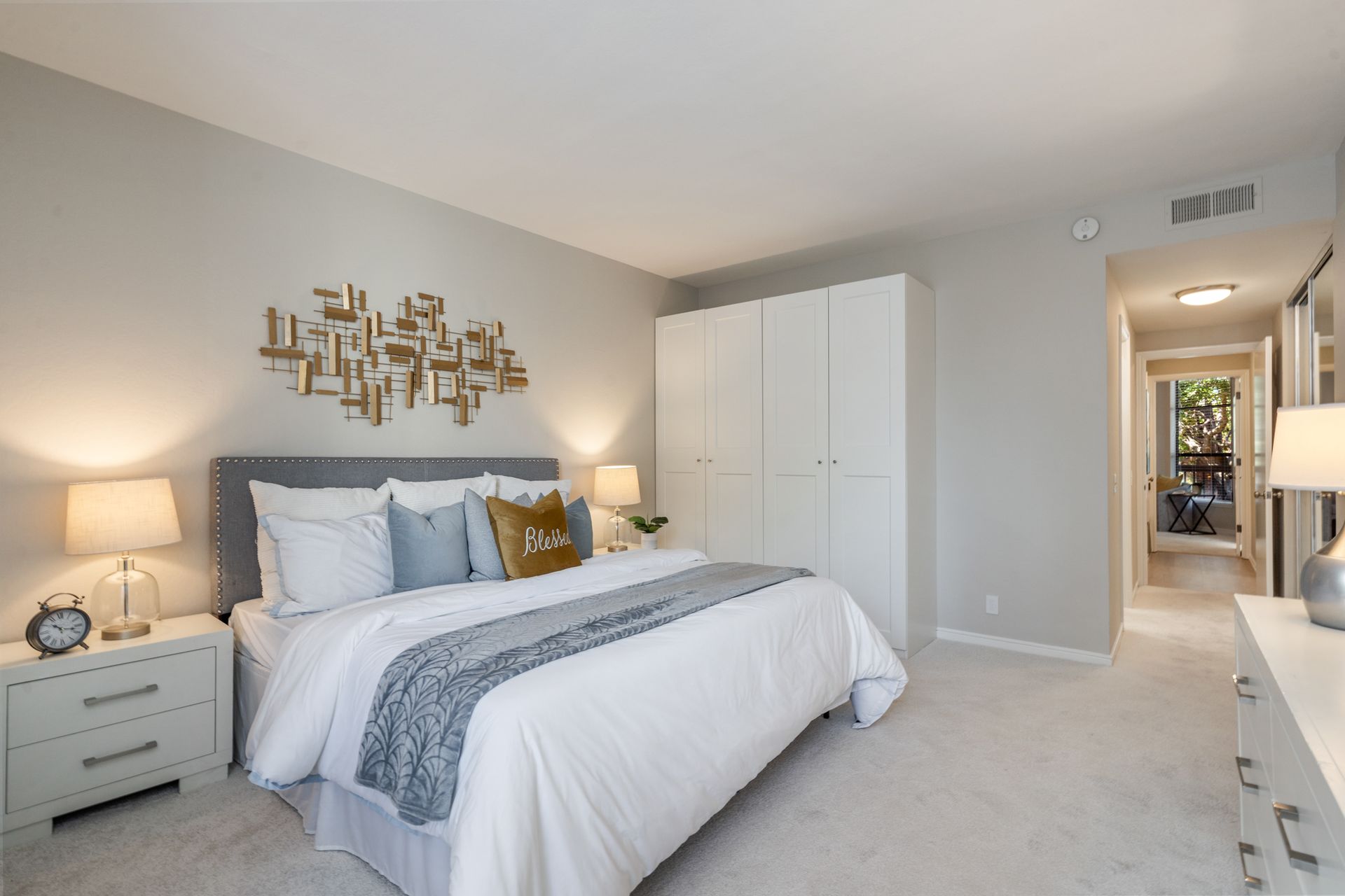 A bedroom with a large bed and a dresser