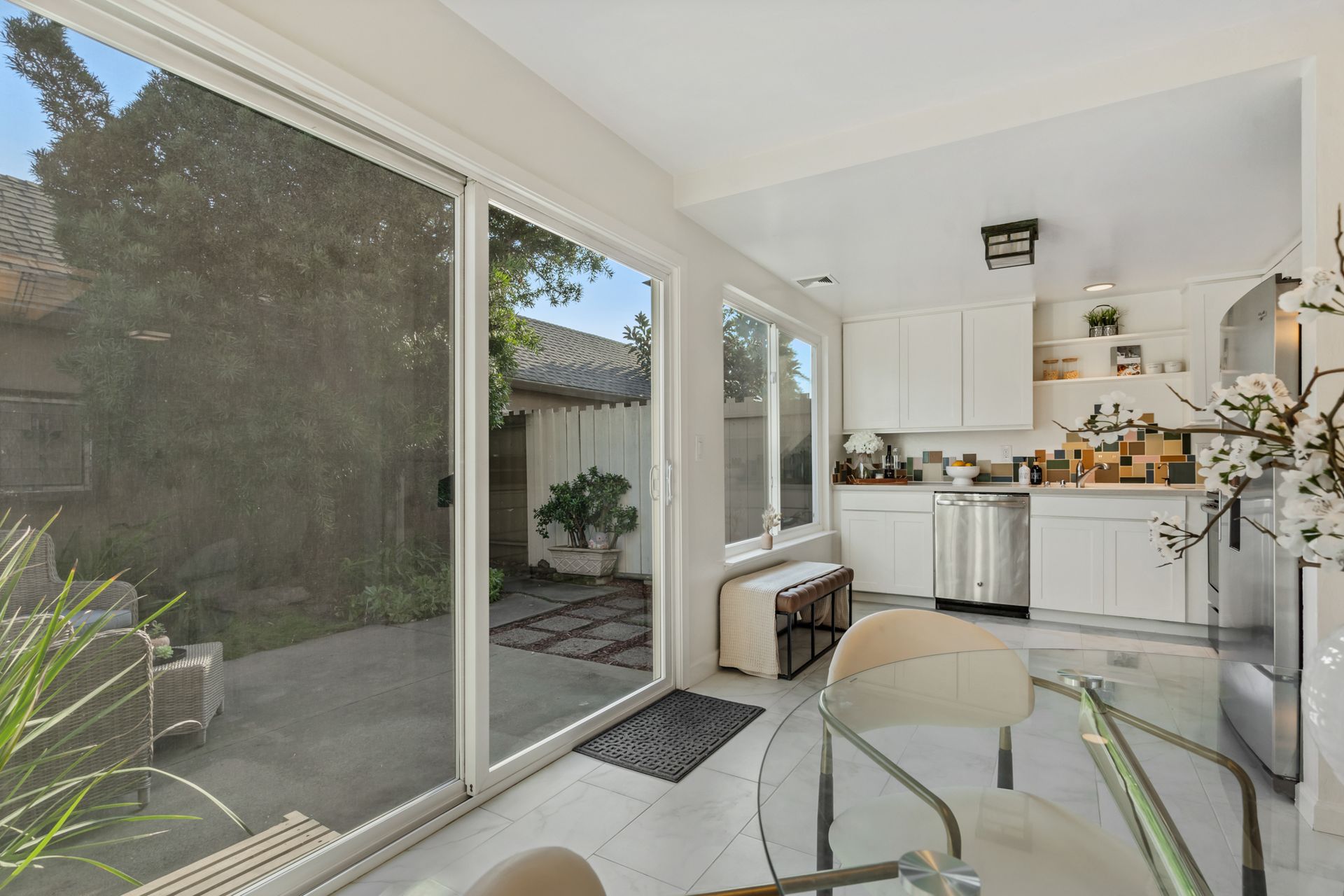 A kitchen with sliding glass doors and a table and chairs