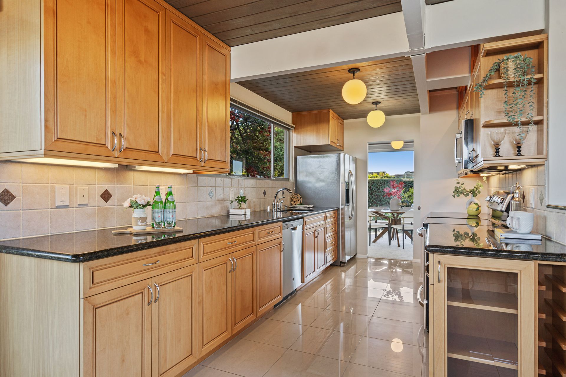 A kitchen with wooden cabinets and granite counter tops