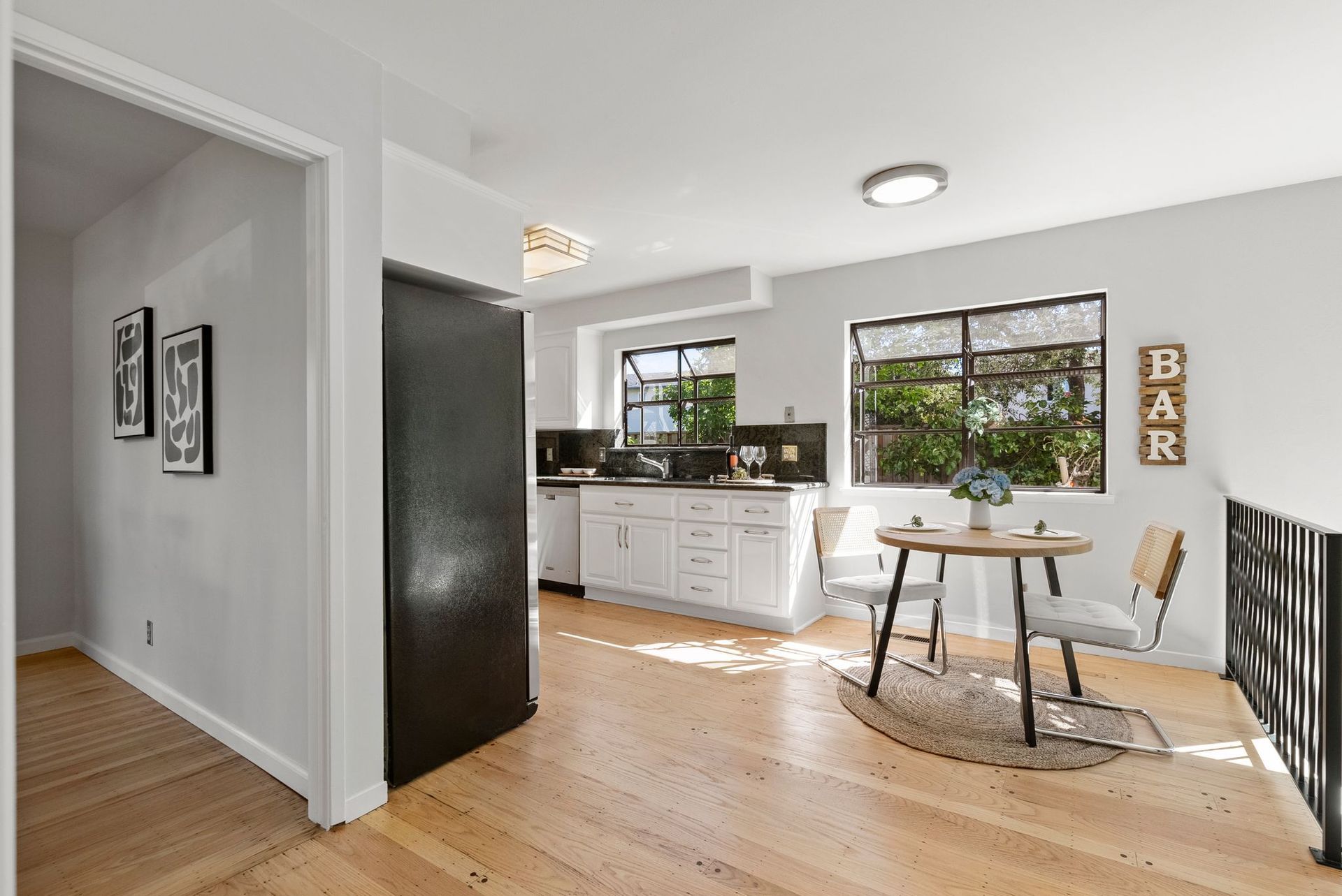 There is a table and chairs in the middle of the room.