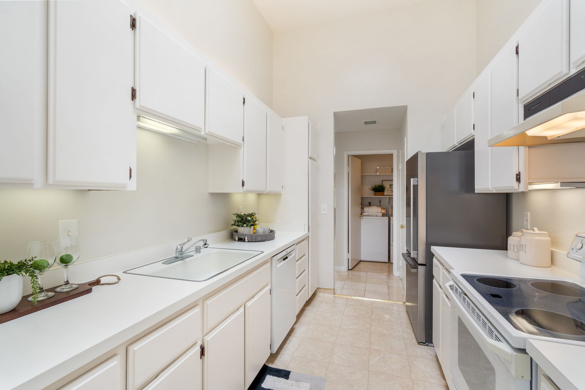 A kitchen with white cabinets and stainless steel appliances