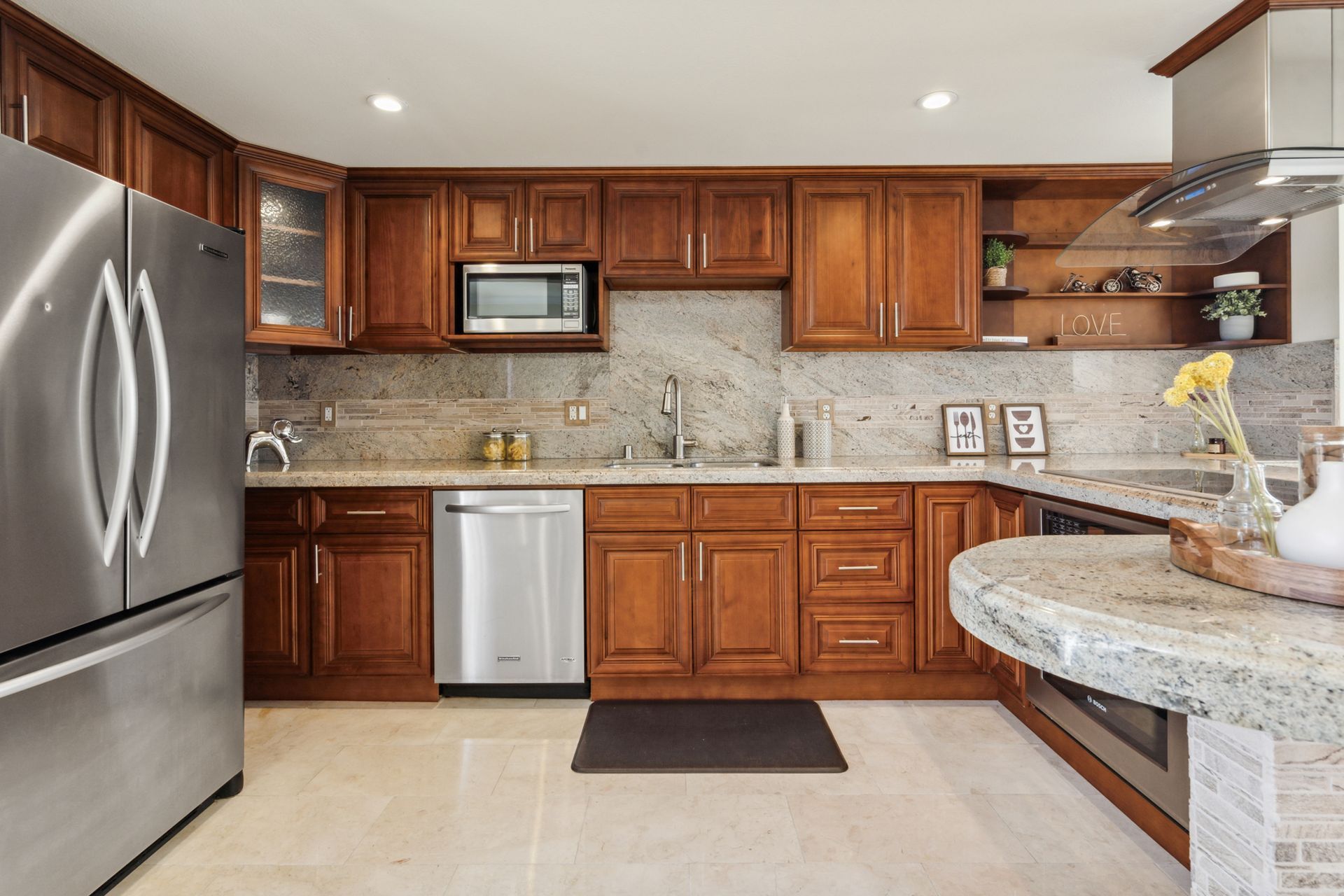 A kitchen with stainless steel appliances and wooden cabinets