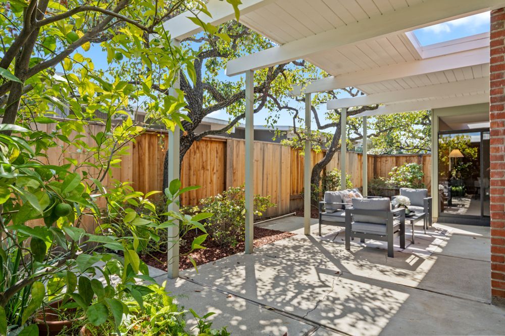 Private backyard with patio and garden vignettes, presented by Rumana Jabeen & Associates to illustrate lifestyle buyers seek and sellers can confidently showcase.