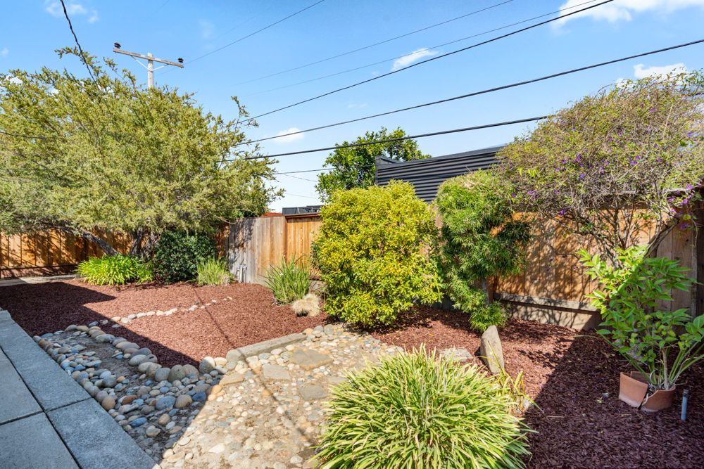 Private backyard with patio and garden vignettes, presented by Rumana Jabeen & Associates to illustrate lifestyle buyers seek and sellers can confidently showcase.