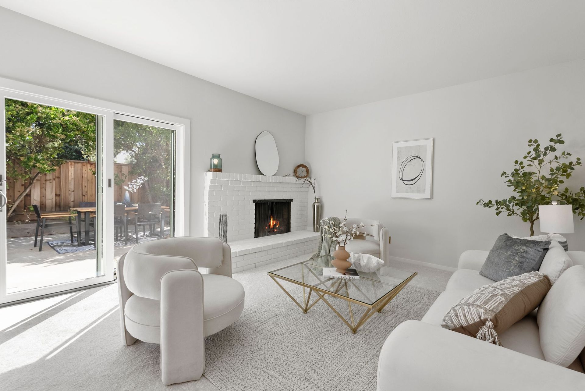 A living room with a couch , chair , coffee table and fireplace.