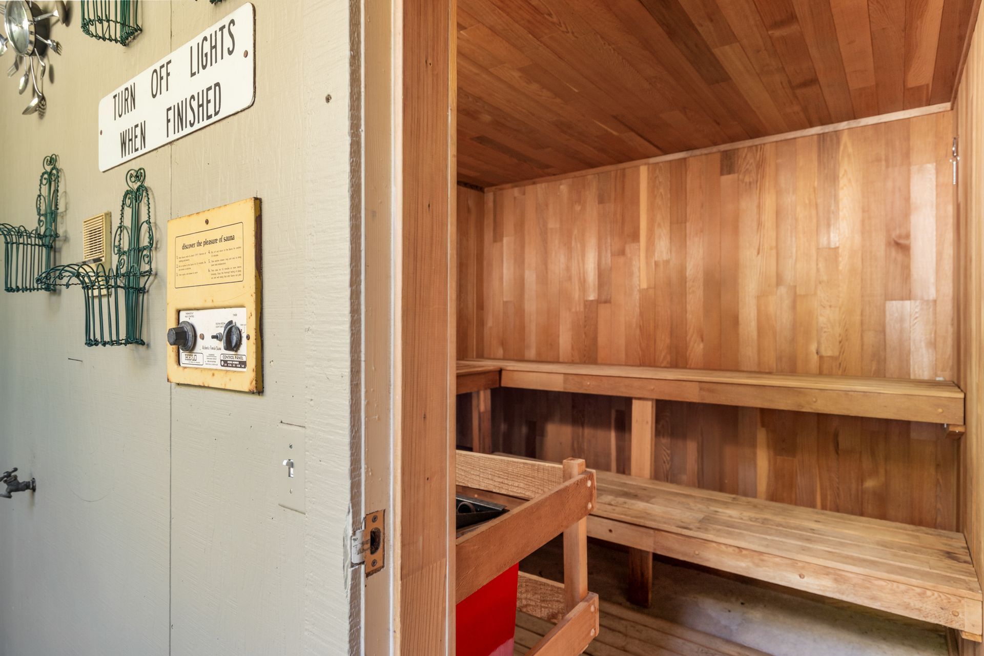 A wooden sauna with a sign on the wall.