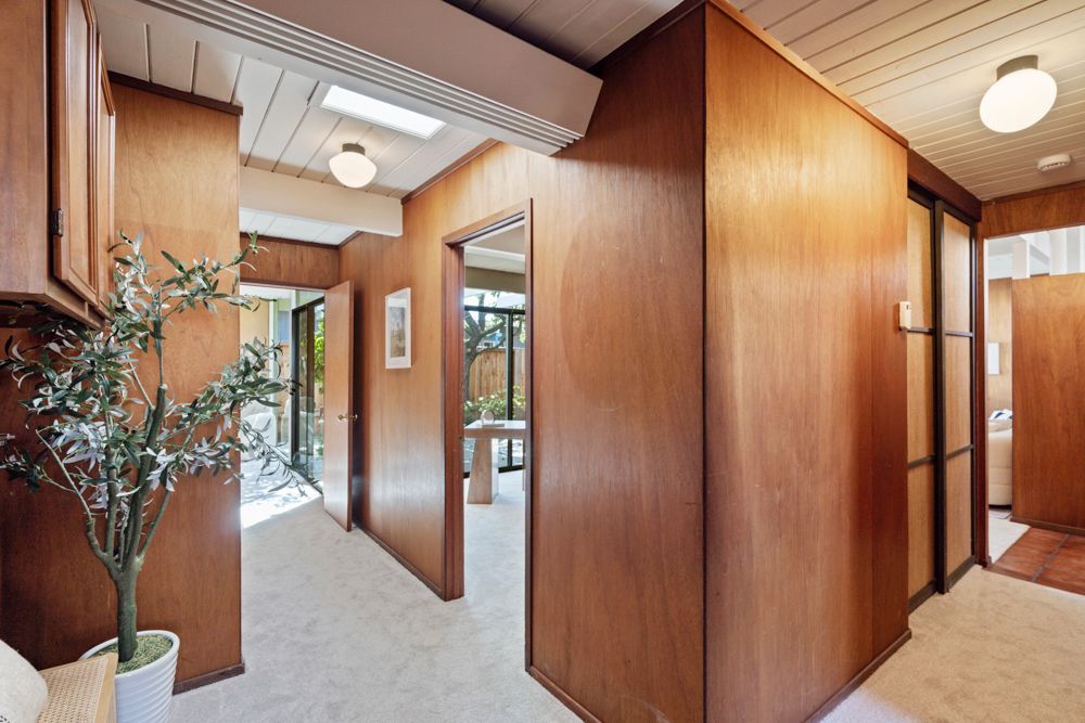 Calm primary bedroom with patio views, dual closets, and ensuite bath — Rumana Jabeen & Associates emphasize comfort for buyers and marketing strength for sellers