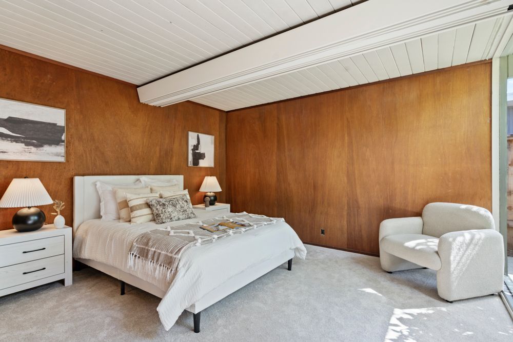 Calm primary bedroom with patio views, dual closets, and ensuite bath — Rumana Jabeen & Associates emphasize comfort for buyers and marketing strength for sellers