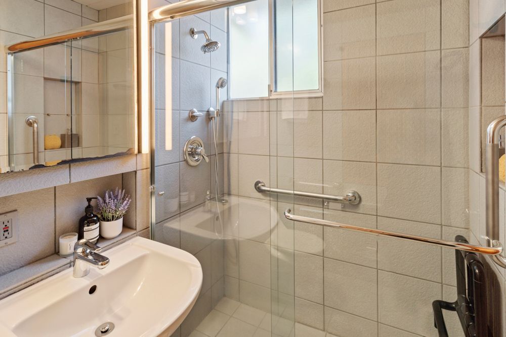 Calm primary bedroom with patio views, dual closets, and ensuite bath — Rumana Jabeen & Associates emphasize comfort for buyers and marketing strength for sellers