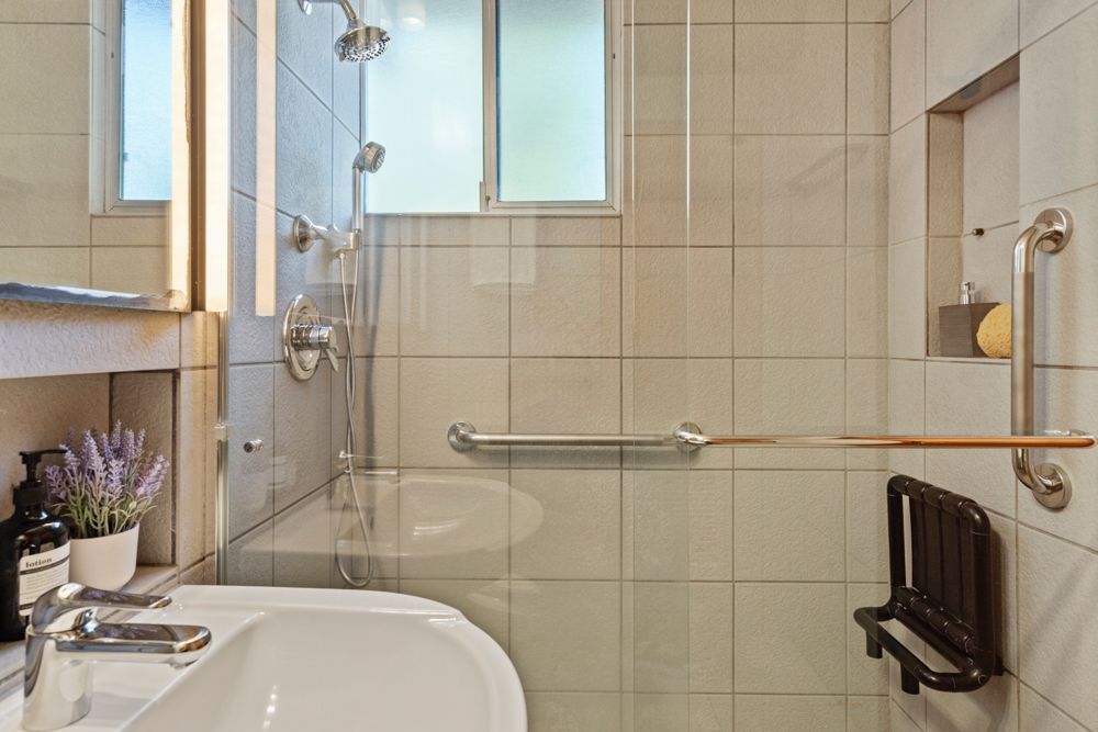 Calm primary bedroom with patio views, dual closets, and ensuite bath — Rumana Jabeen & Associates emphasize comfort for buyers and marketing strength for sellers