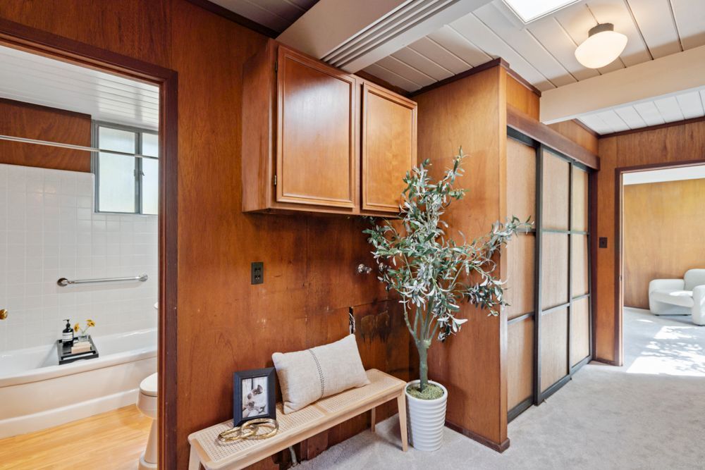 Bright secondary bedroom with large window and mid-century details, highlighted by Rumana Jabeen & Associates to inspire buyers and show sellers thoughtful presentation.