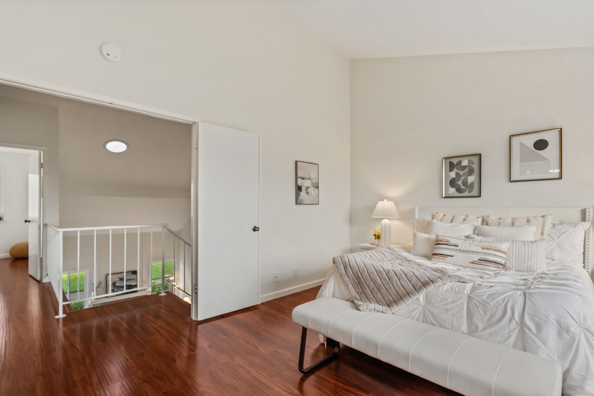 A bedroom with a bed and a bench in it.