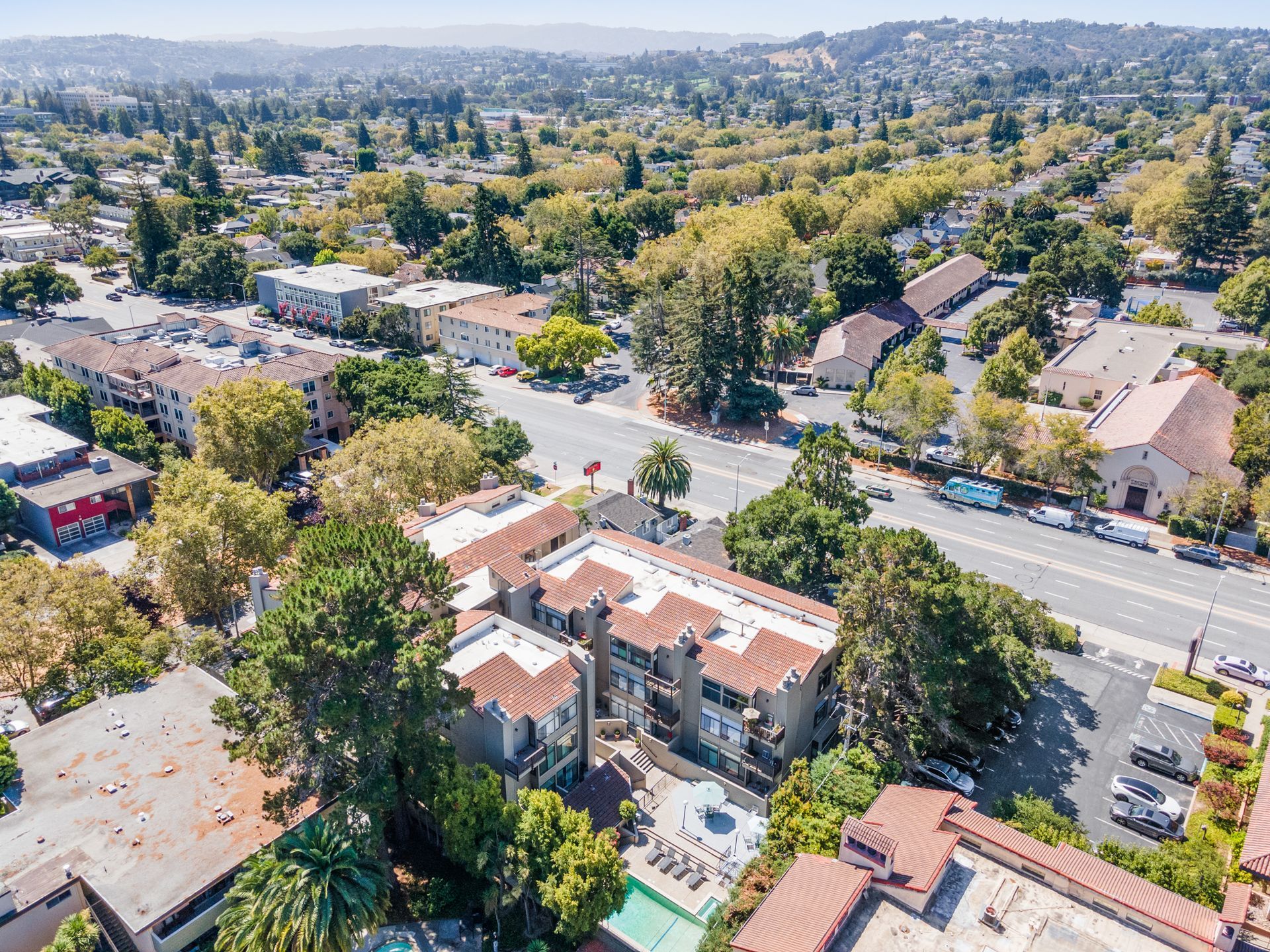 An aerial view of a residential area with lots of buildings and trees.