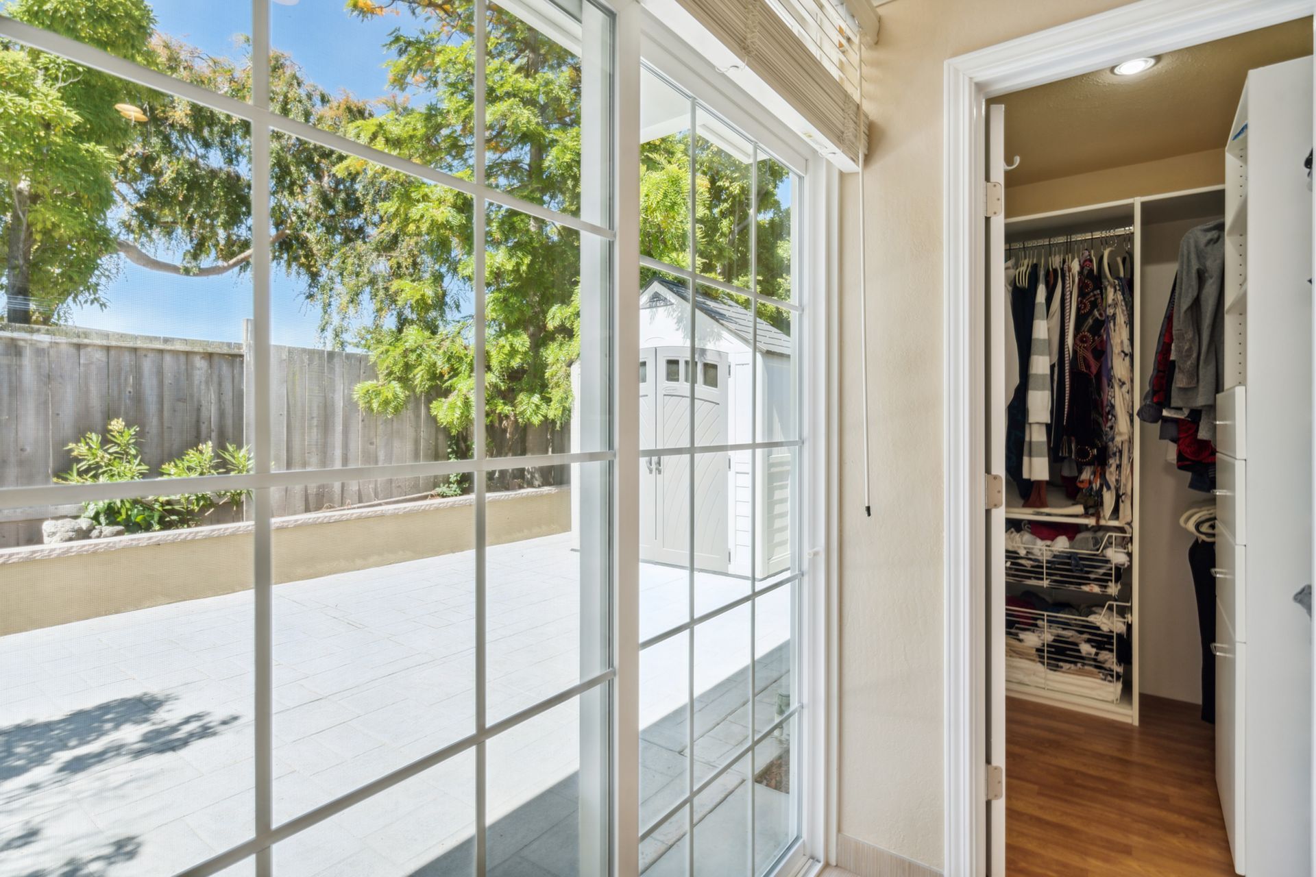 There is a sliding glass door leading to a walk in closet.