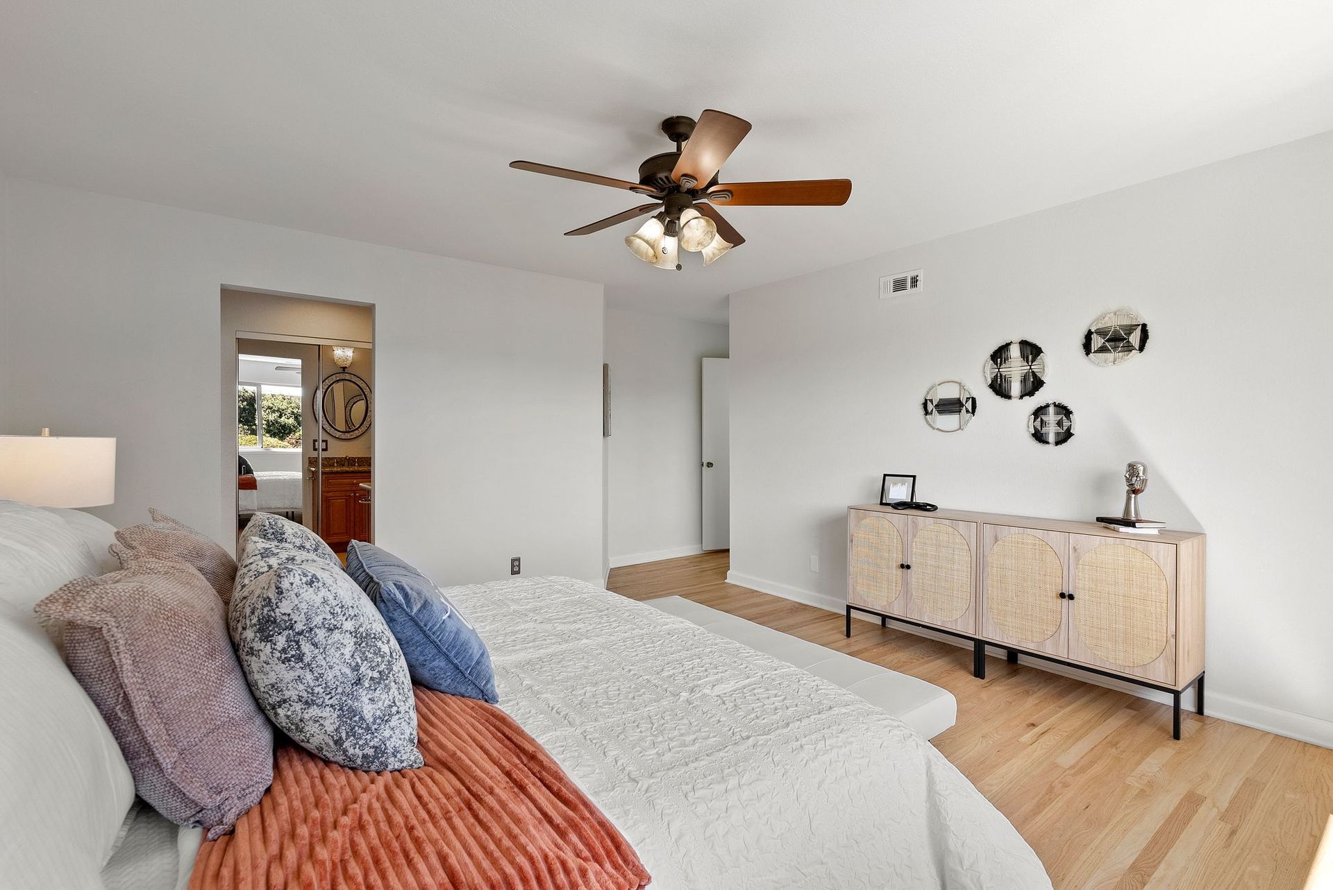 A bedroom with a bed and a ceiling fan