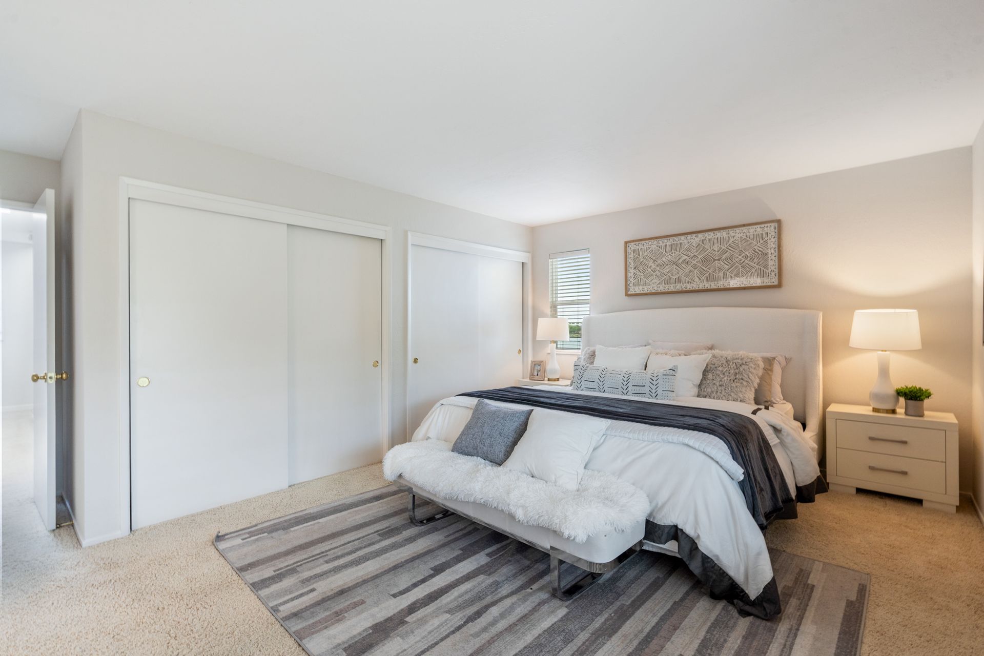 A bedroom with a king size bed and a futon.