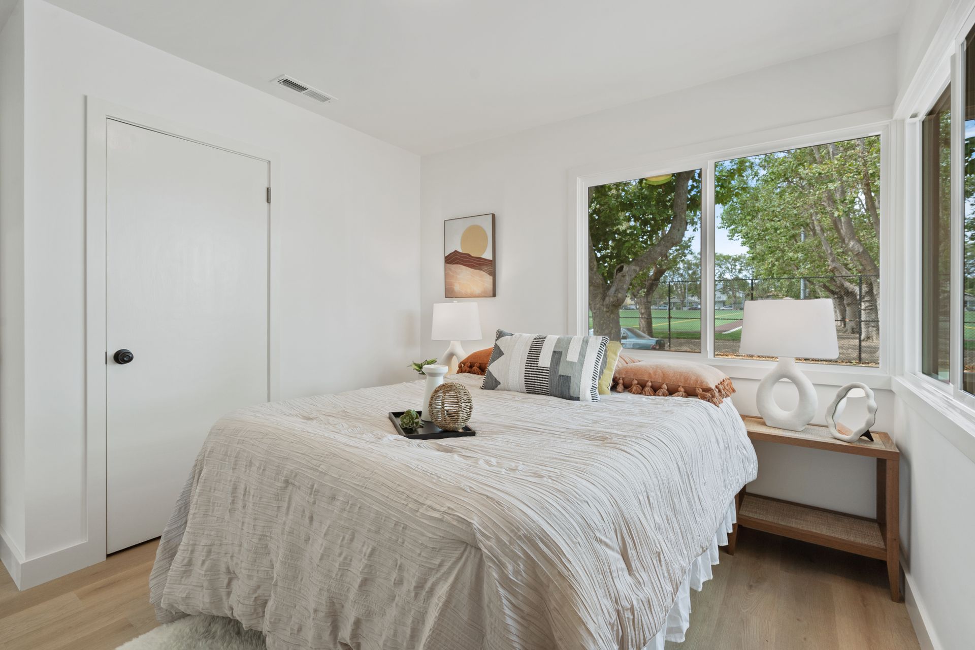 A bedroom with a large bed and a large window.