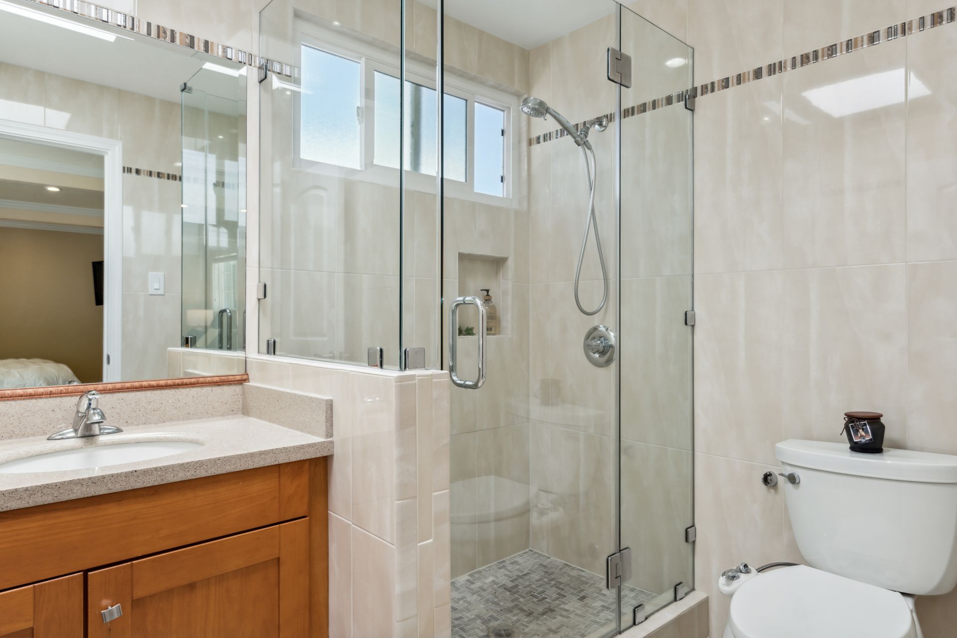 A bathroom with a toilet , sink and walk in shower.