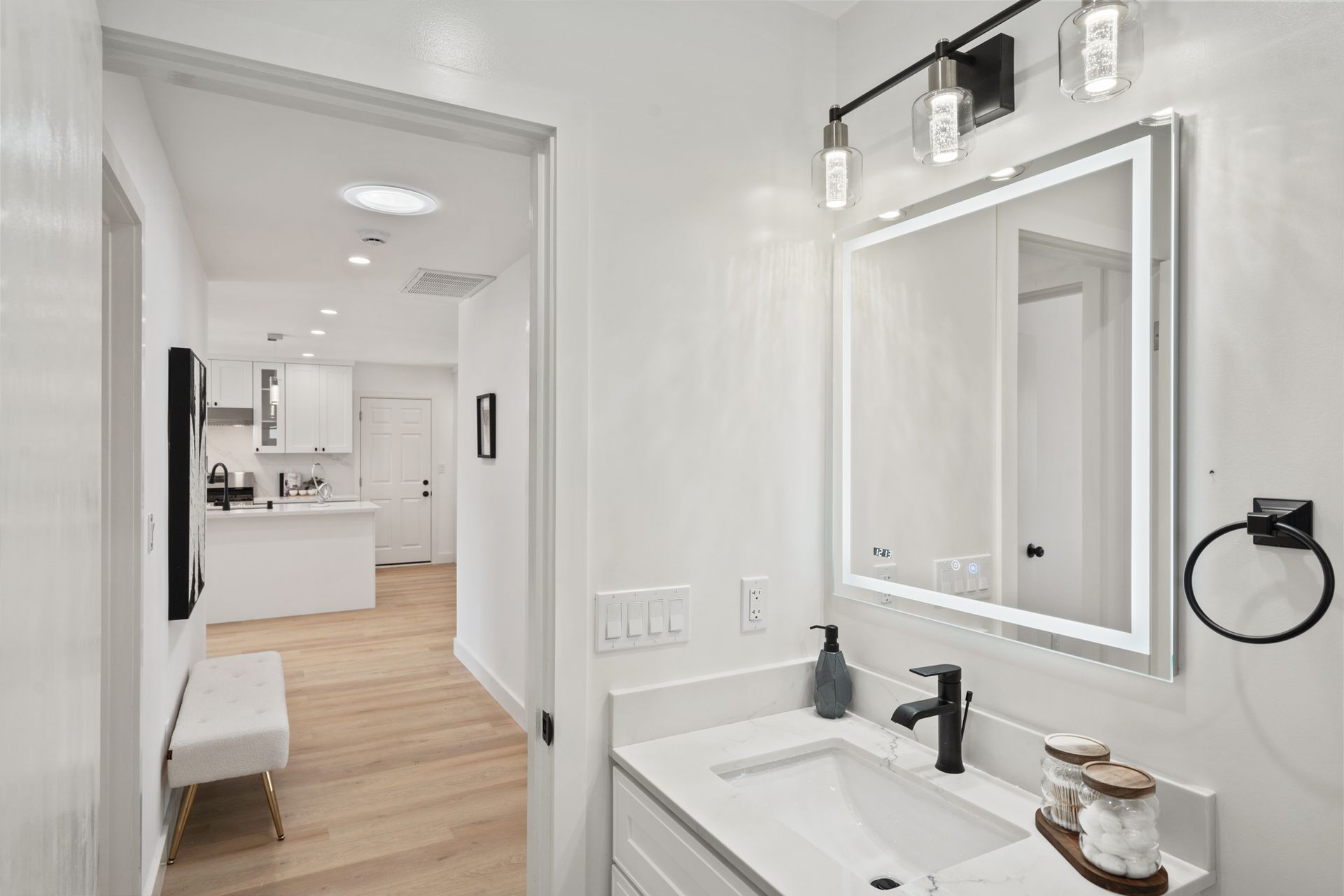 A bathroom with a sink and a mirror.