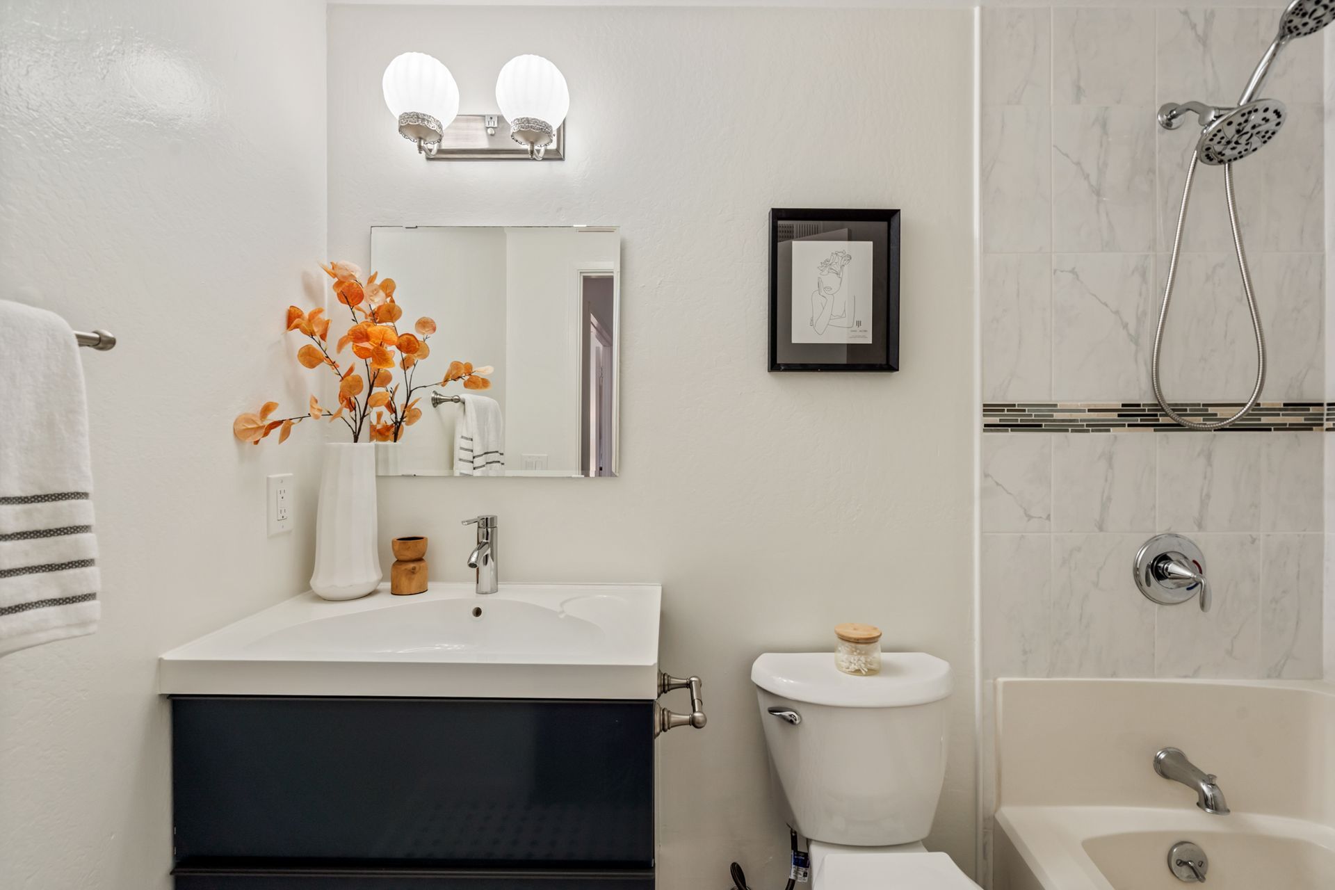 A bathroom with a sink , toilet , tub and shower.