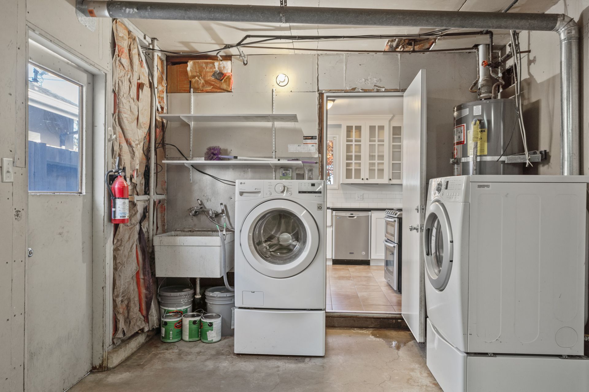 A laundry room with a washer and dryer and a sink.