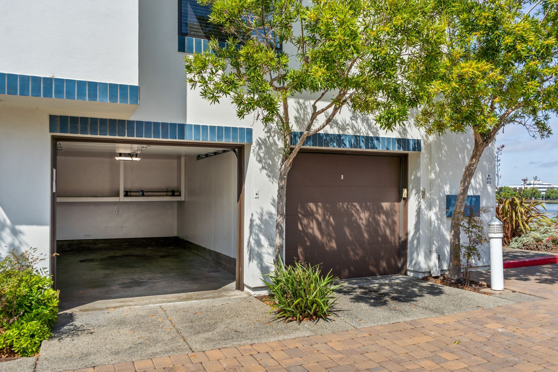 A white building with a brown garage door