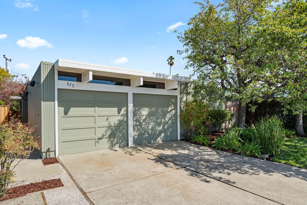 Welcoming mid-century exterior framed by mature landscaping, presented by Rumana Jabeen & Associates to inspire buyers and show sellers how curb appeal is marketed.
